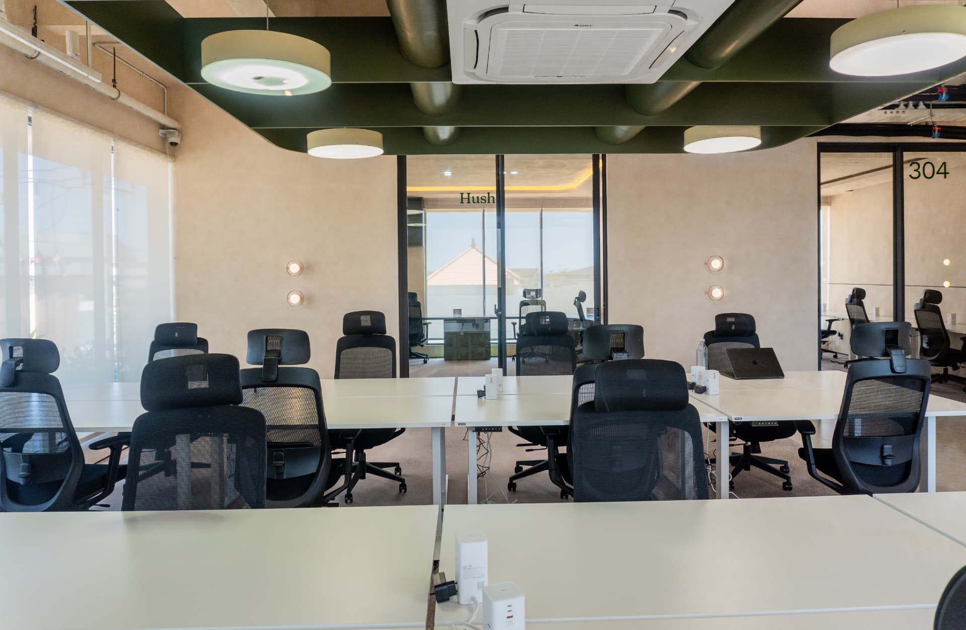 The dedicated desk floor at Argil in Pererenan, with fixed desks beside the Hush room glazing